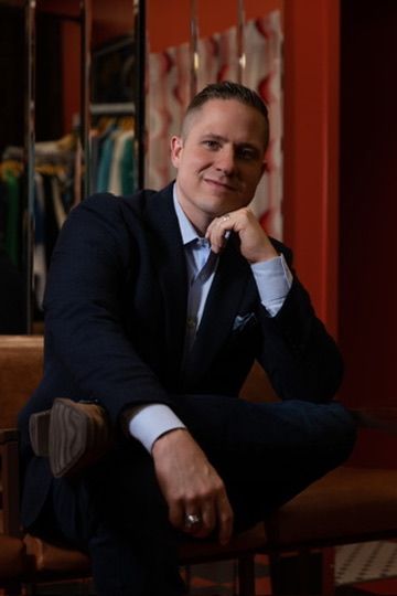 Aaron Glover headshot: seated, editorial