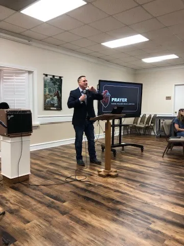 Aaron leading a session on prayer in a meeting room